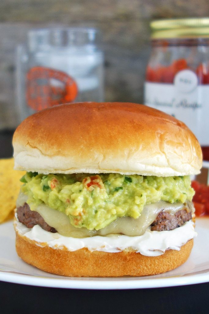 Guacamole burger topped with fresh quac, sour cream, and pepper jack cheese